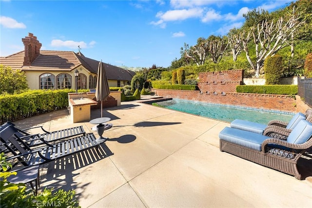 outdoor pool with a patio area