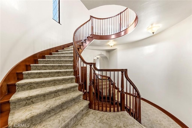 staircase with carpet flooring and baseboards