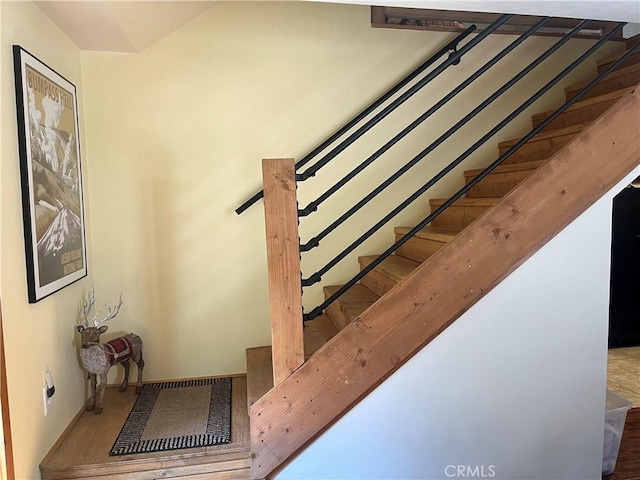 stairway featuring visible vents and baseboards