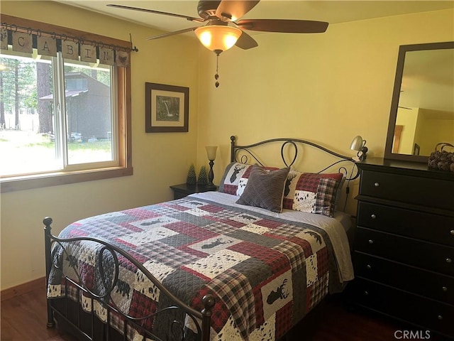 bedroom with baseboards, a ceiling fan, and wood finished floors