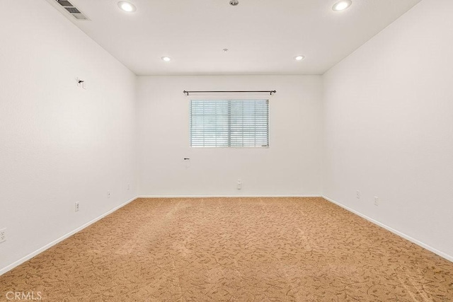 empty room with light colored carpet, baseboards, visible vents, and recessed lighting