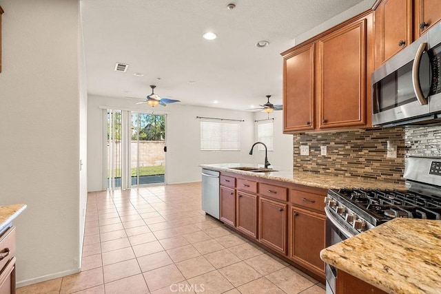 kitchen with ceiling fan, a sink, visible vents, and stainless steel appliances