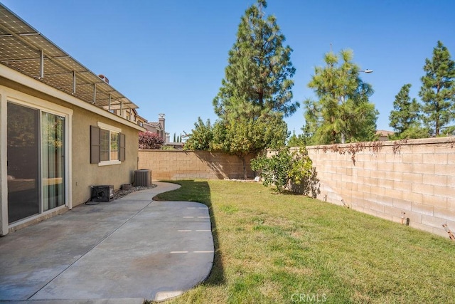 view of yard with central air condition unit, a fenced backyard, and a patio area