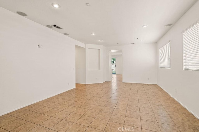 unfurnished room featuring recessed lighting, visible vents, baseboards, and light tile patterned flooring