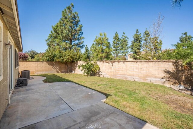 view of yard with cooling unit, a patio, and a fenced backyard