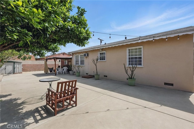 5411 La Madera Ave, El Monte, CA 91732 - back of house with stucco siding, a shed, a patio area, an outbuilding, and fence
