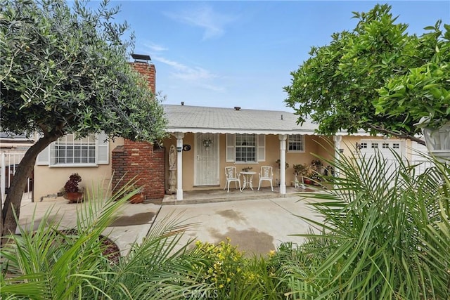 5411 La Madera Ave, El Monte, CA 91732 - rear view of property featuring a chimney, covered porch, and stucco siding