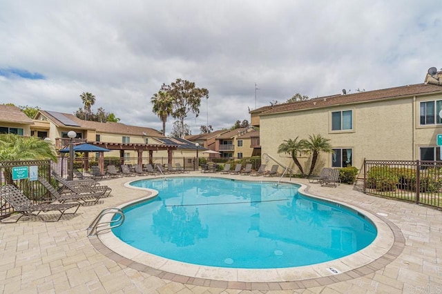 pool featuring fence, a gazebo, a patio area, and a residential view