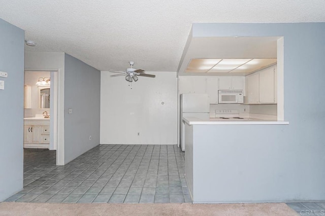 kitchen with white cabinets, ceiling fan, white appliances, light countertops, and a peninsula