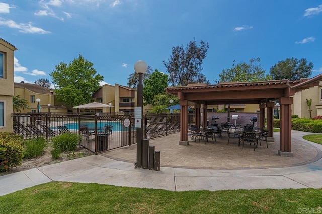 pool with a gazebo, a patio area, and fence