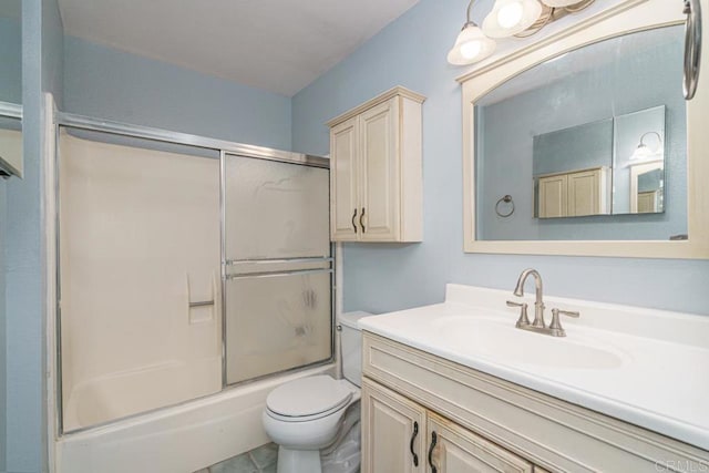 bathroom with vanity, combined bath / shower with glass door, and toilet