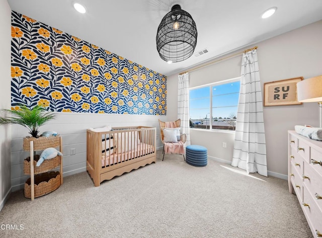 bedroom featuring a nursery area, visible vents, recessed lighting, carpet flooring, and baseboards
