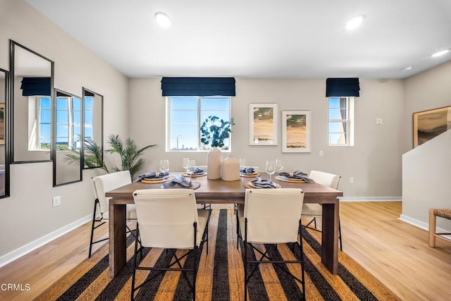 dining area with recessed lighting, baseboards, and wood finished floors