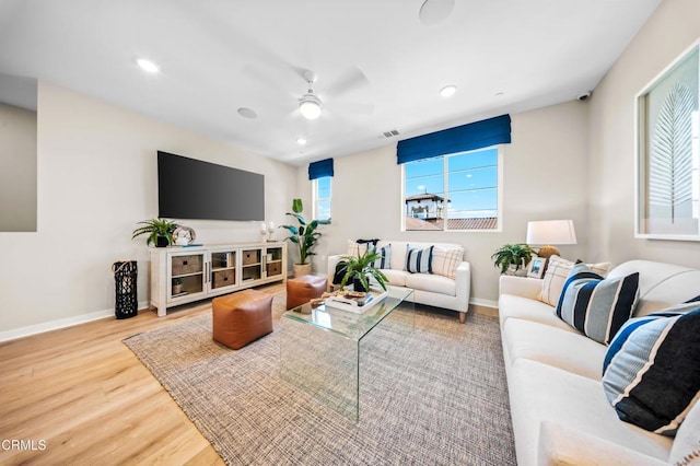 living room featuring recessed lighting, baseboards, a ceiling fan, and wood finished floors