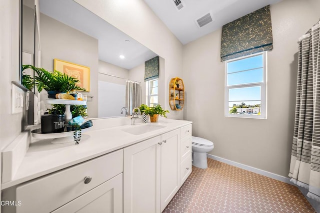 full bath with toilet, visible vents, baseboards, and vanity