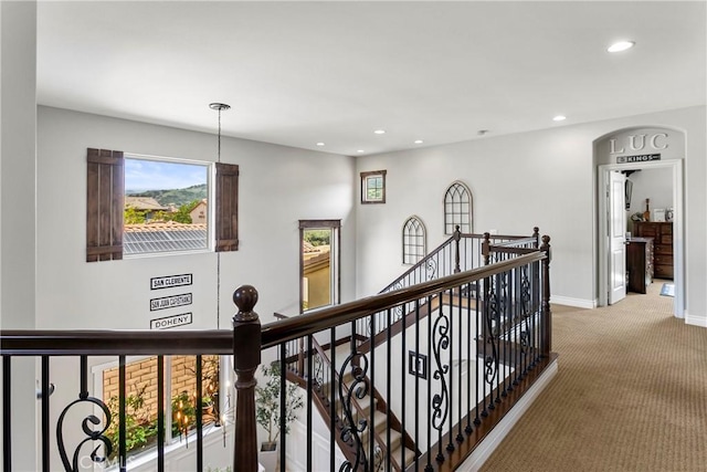 corridor featuring recessed lighting, baseboards, an upstairs landing, and carpet floors