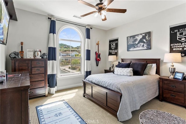 bedroom featuring light carpet, ceiling fan, baseboards, and visible vents