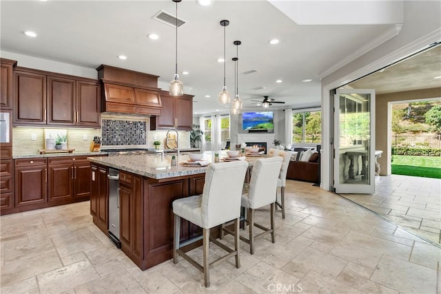 kitchen with recessed lighting, stone tile flooring, visible vents, and a healthy amount of sunlight