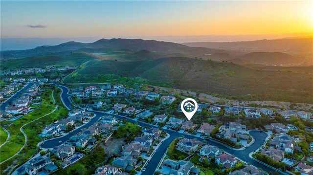aerial view at dusk with a mountain view and a residential view