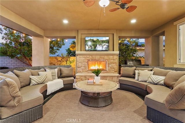 exterior space with a fenced backyard, an outdoor living space with a fireplace, and an outdoor kitchen