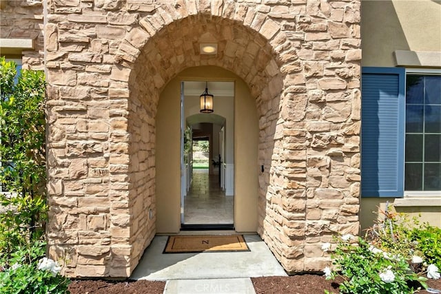 view of exterior entry featuring stone siding