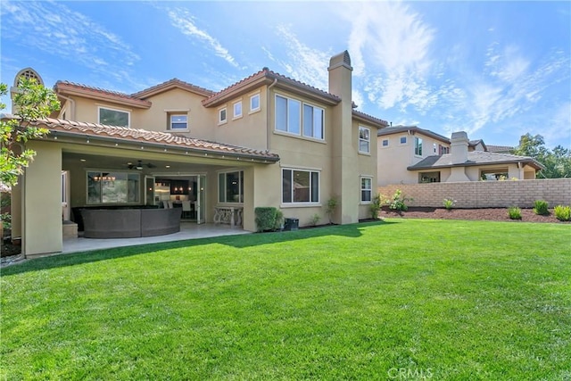 back of property featuring a yard, a patio, ceiling fan, and fence