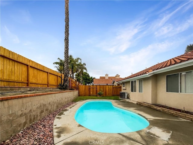 view of swimming pool with a patio area, a fenced backyard, a fenced in pool, and central air condition unit