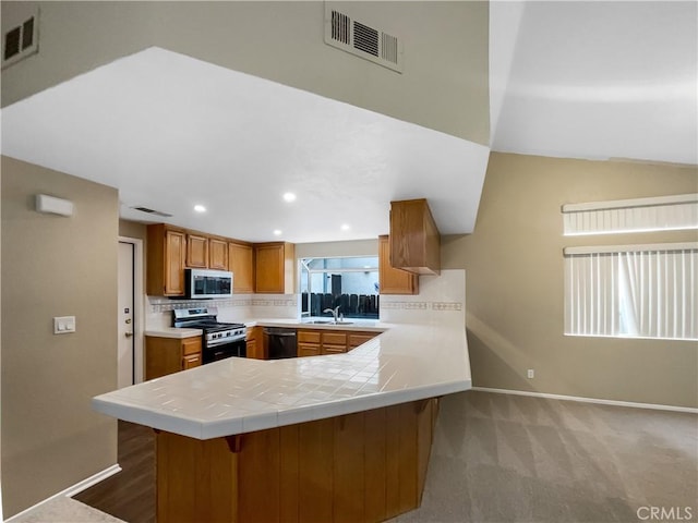 kitchen with baseboards, visible vents, and stainless steel appliances