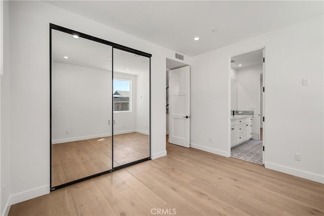 2100 Carnegie Ln, Redondo Beach, CA 90278 - unfurnished bedroom featuring light wood finished floors, recessed lighting, a closet, and ensuite bath