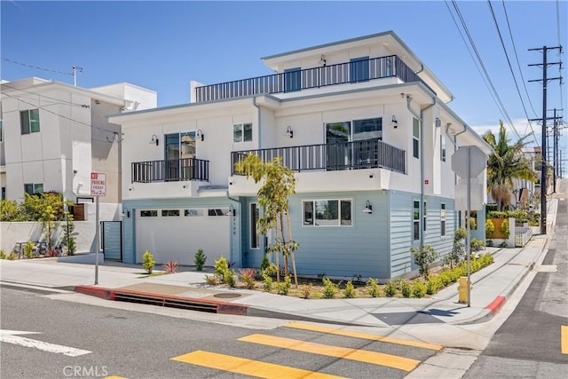 2100 Carnegie Ln, Redondo Beach, CA 90278 - view of front of property featuring a balcony, a garage, driveway, and stucco siding