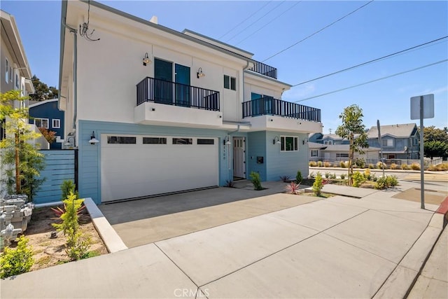 2100 Carnegie Ln, Redondo Beach, CA 90278 - view of front facade featuring a balcony, a garage, concrete driveway, and stucco siding