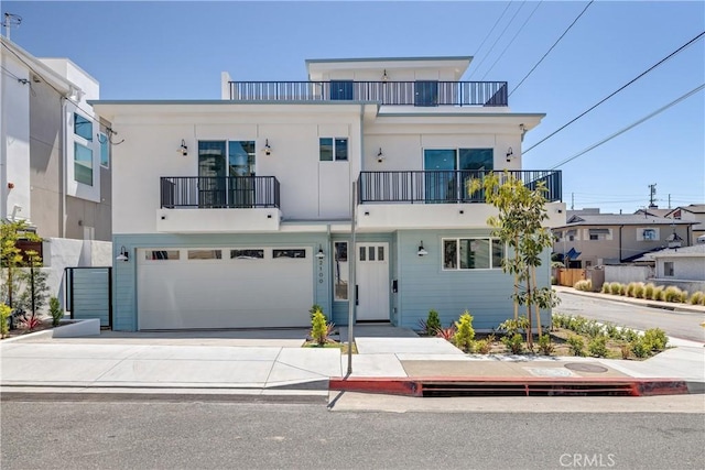 2100 Carnegie Ln, Redondo Beach, CA 90278 - view of front of house featuring a balcony, driveway, a garage, and stucco siding