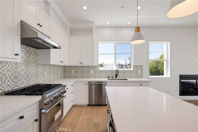 2100 Carnegie Ln, Redondo Beach, CA 90278 - kitchen with stainless steel appliances, under cabinet range hood, light wood-style flooring, white cabinets, and recessed lighting