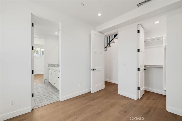 2100 Carnegie Ln, Redondo Beach, CA 90278 - unfurnished bedroom featuring light wood-style floors, a spacious closet, recessed lighting, and ensuite bathroom