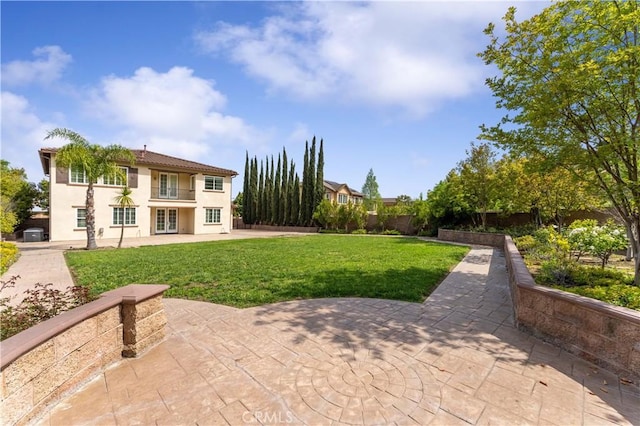 view of yard featuring a patio and a balcony