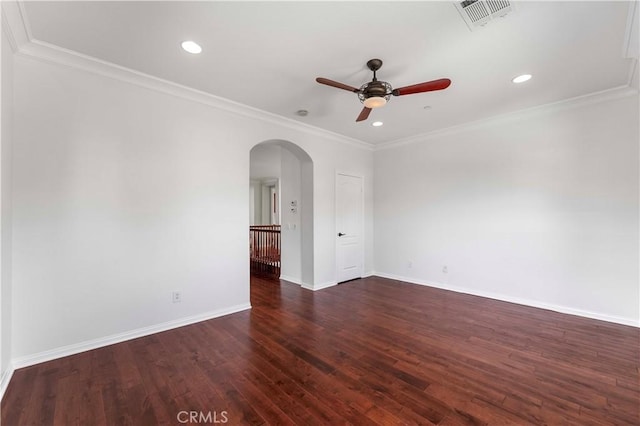 spare room featuring visible vents, baseboards, arched walkways, ceiling fan, and dark wood finished floors