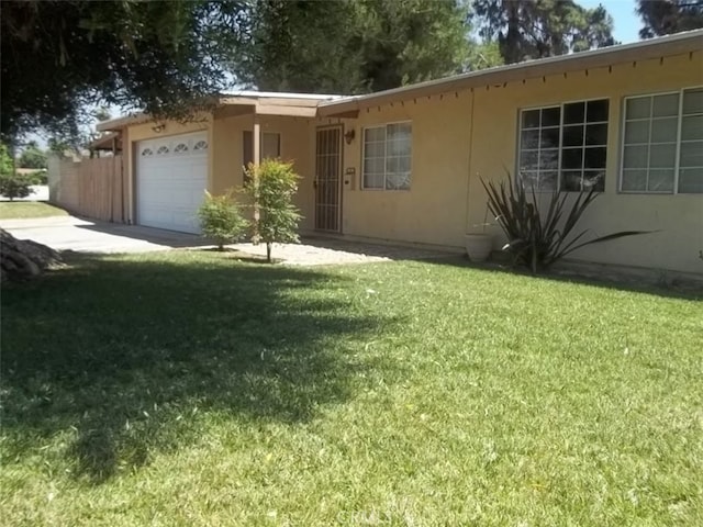 406 S Lowell St, Covina, CA 91723 - ranch-style house featuring an attached garage, a front lawn, and stucco siding