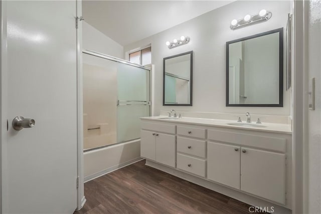 11962 Verona Dr, Fontana, CA 92337 - bathroom with shower / bath combination with glass door, wood finished floors, double vanity, and a sink