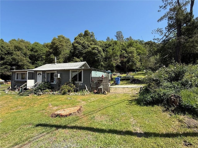 exterior space featuring a forest view and a lawn