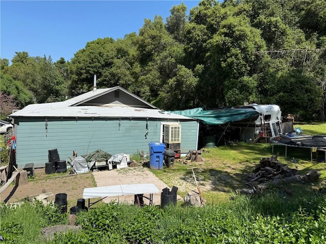 rear view of house with a wooded view