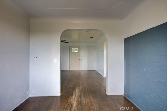1124 S Moffett Rd, Turlock, CA 95380 - hall with arched walkways, baseboards, and wood finished floors