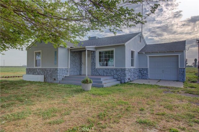 1124 S Moffett Rd, Turlock, CA 95380 - view of front of property with a front yard, stone siding, a garage, and stucco siding