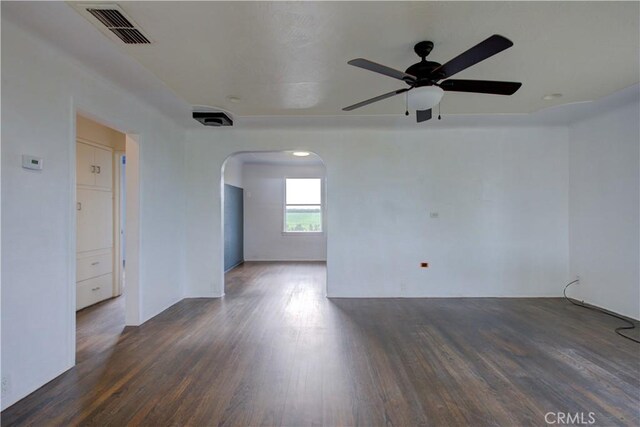 1124 S Moffett Rd, Turlock, CA 95380 - empty room featuring visible vents, ceiling fan, arched walkways, and wood finished floors