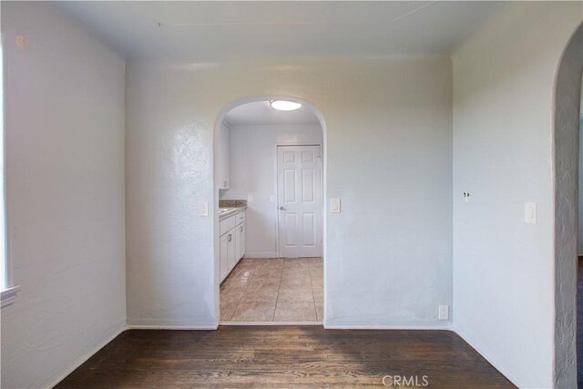 1124 S Moffett Rd, Turlock, CA 95380 - hall featuring arched walkways, wood finished floors, and baseboards