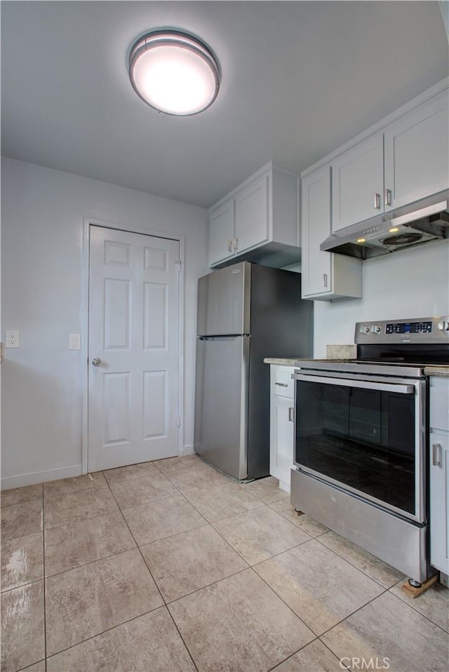1124 S Moffett Rd, Turlock, CA 95380 - kitchen featuring light tile patterned floors, baseboards, under cabinet range hood, white cabinetry, and stainless steel appliances