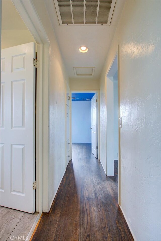 1124 S Moffett Rd, Turlock, CA 95380 - hallway featuring visible vents, baseboards, attic access, and wood finished floors