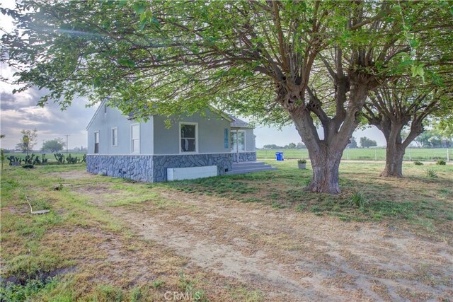 1124 S Moffett Rd, Turlock, CA 95380 - view of side of home with stucco siding and stone siding