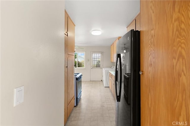 8751 Oasis Ave, Westminster, CA 92683 - kitchen with gas range oven, washing machine and dryer, light countertops, freestanding refrigerator, and light floors