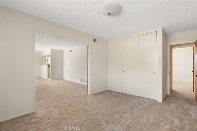 8751 Oasis Ave, Westminster, CA 92683 - unfurnished bedroom featuring visible vents, a closet, light carpet, and a textured ceiling
