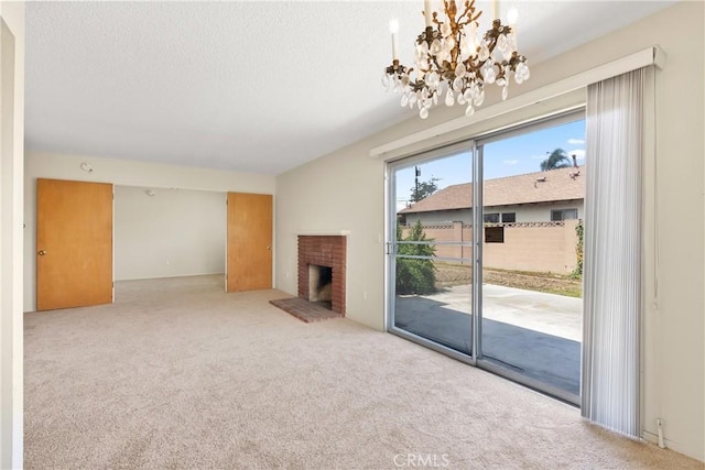8751 Oasis Ave, Westminster, CA 92683 - unfurnished living room featuring a textured ceiling, an inviting chandelier, carpet, and a fireplace